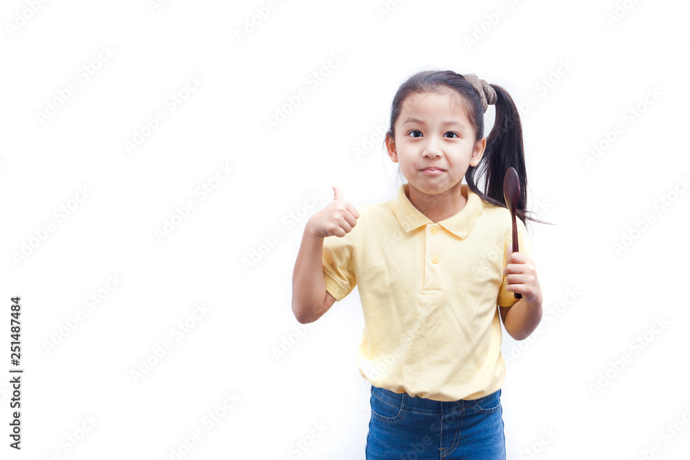 Little girl holding wooden spoon and thumbs up, on white background. Little girl holding wooden spoon and thumbs up, on white background.