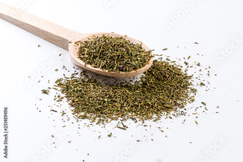 thyme herb in wooden spoon isolated on white background
