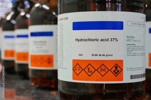 Bottle of Hydrochloric Acid, HCL with Properties information and its chemical hazard warning symbols. Corrosive, Inhalation,Toxic warning, Hazardous to the Environment.