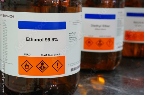 Bottle of Ethanol, C2H6O with Properties information and its chemical hazard warning symbols. Flammable symbol, Inhalation hazard symbol.