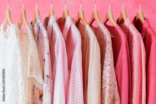 Fotografie Pink colored women clothes hanging in row on rack