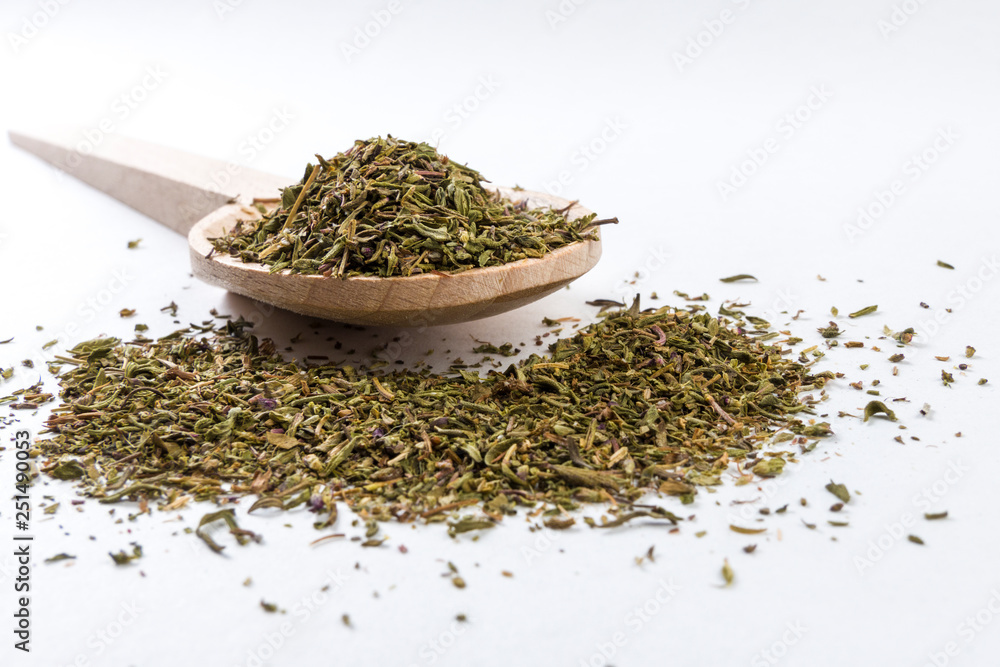 thyme herb in wooden spoon isolated on white background thyme herb in wooden spoon isolated on white background