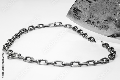 The steel chain is cut by a metal blade.