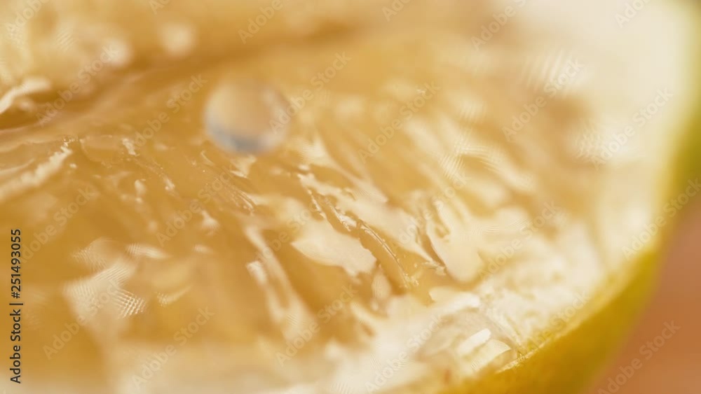 SLOW MOTION, MACRO, DOF: Droplets of refreshing water fall onto the aromatic lemon slice. Drops of freshly squeezed lemon juice fall onto the piece of an organic lemon. Fragrant homegrown fruit. SLOW MOTION, MACRO, DOF: Droplets of refreshing water fall onto the aromatic lemon slice. Drops of freshly squeezed lemon juice fall onto the piece of an organic lemon. Fragrant homegrown fruit.