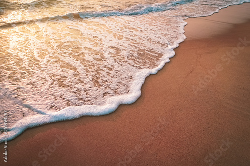 Fototapeta Naklejka Na Ścianę i Meble -  Sunset beach and smooth wave abstract texture background.