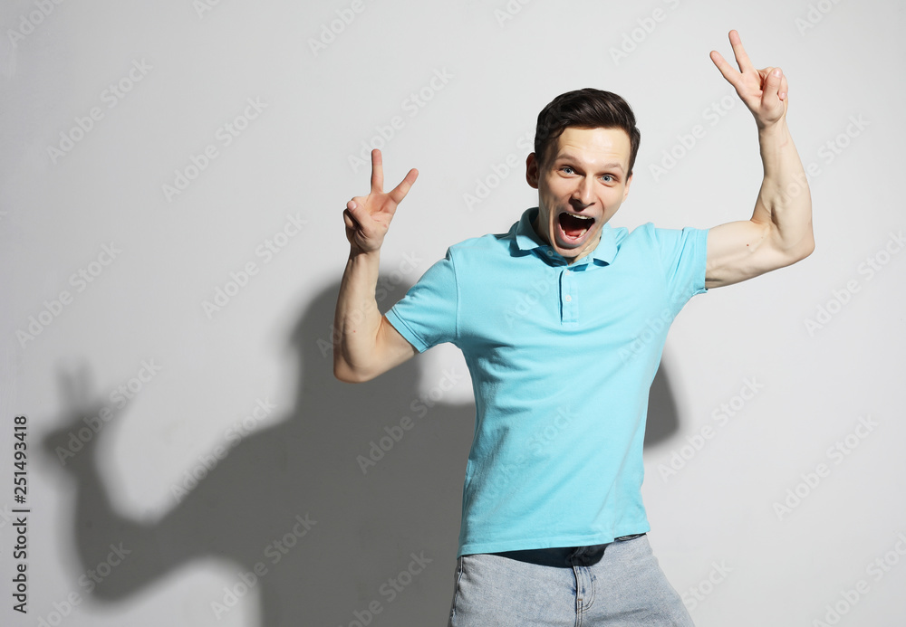 Fototapeta premium young man celebrating victory over white background