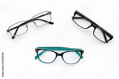 Set of glasses with transparent lenses on white background top view