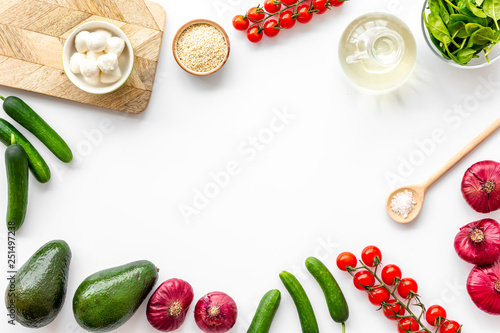 Fresh organic vegetables on white background top view space for text. Kitchen desk for preparing salad frame