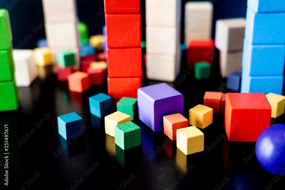 Obraz premium Toy wood blocks for Children to play with on black background