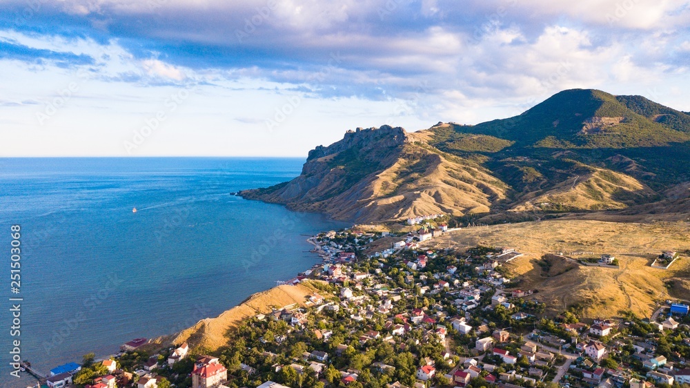 Panorama of the city of Koktebel on the background of mountains and the sea. Crimea