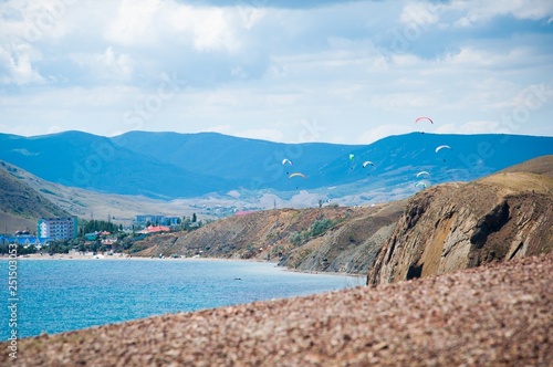 Fototapeta Naklejka Na Ścianę i Meble -  Paroplanes on the background of mountains and the sea. Crimea. Koktebel.
