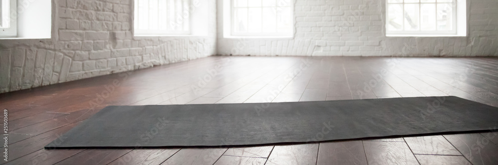 Horizontal photo yoga mat on wooden floor at sport club Horizontal photo yoga mat on wooden floor at sport club