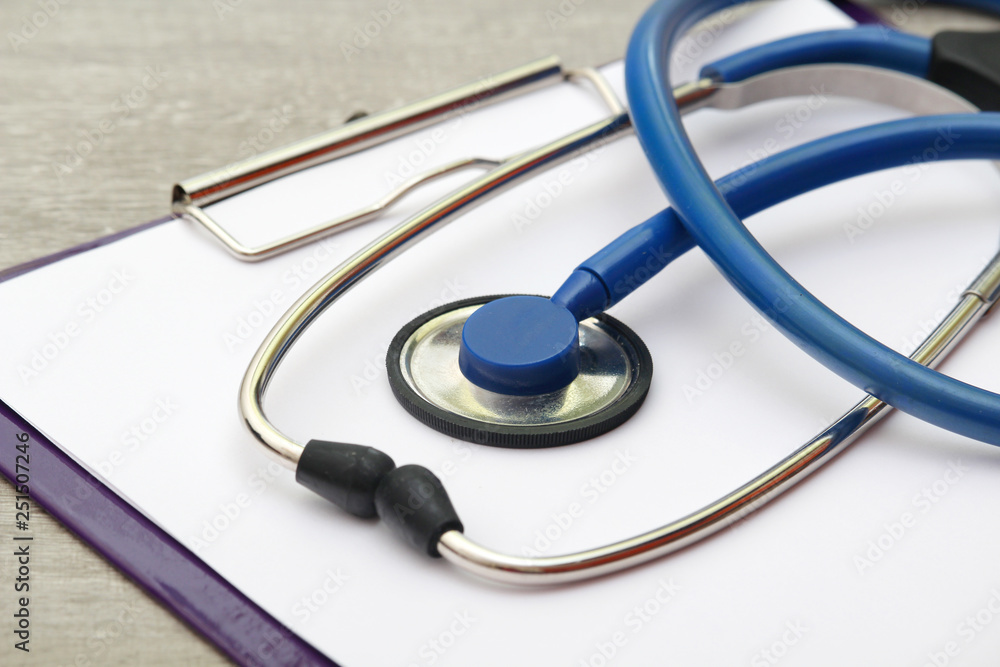 A stethoscope and a clipboard for notes as a medical check concept A stethoscope and a clipboard for notes as a medical check concept