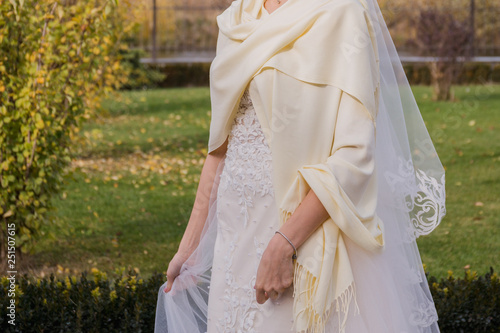 bride waves a dress in the wind in the park