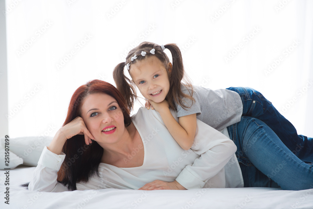 Happy loving family. Mother and her daughter child girl playing and hugging Happy loving family. Mother and her daughter child girl playing and hugging