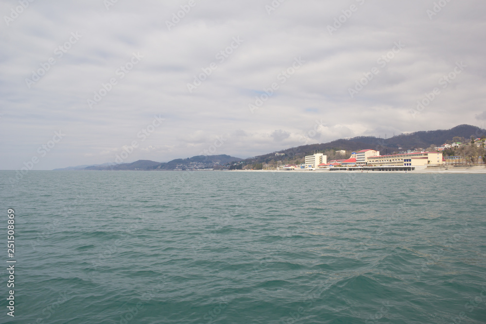 Resorts and holiday homes on the Black sea in the vicinity of Sochi. Landscapes villages Uch-Dere, Loo and Dagomys on a cloudy day from the sea