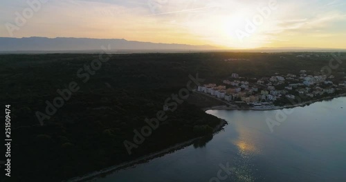 City on the croatian shore, C4k aerial, tracking, drone shot, panning around Kozino town on the mediterranean coast, adriatic sea, near Zadar city, on a sunny, sunrise, summer dusk, in Croatia