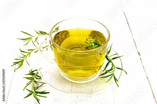 Tea of rosemary in cup on light board