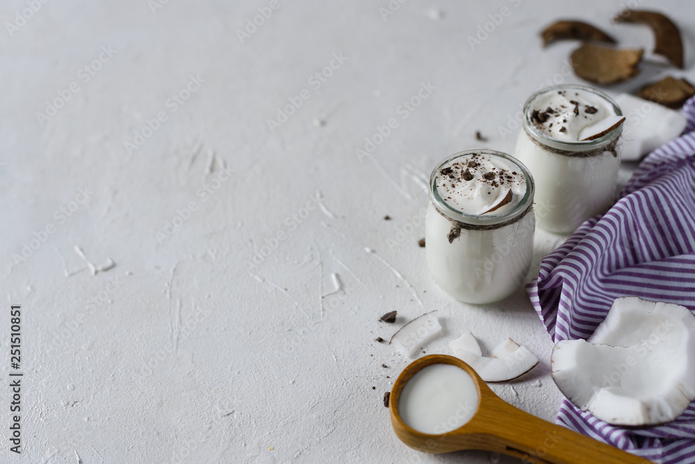 Organic coconut yogurt in glass jar with coconut,chocolate, dairy free yogurt, probiotic food