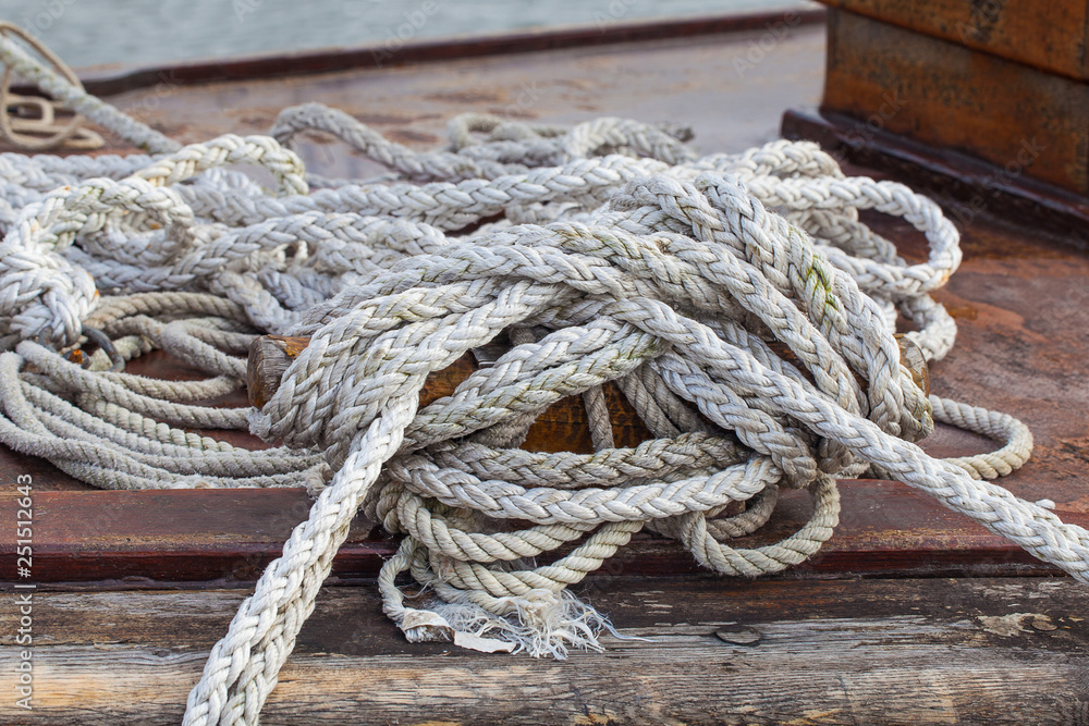 Rope on a yacht on wooden background