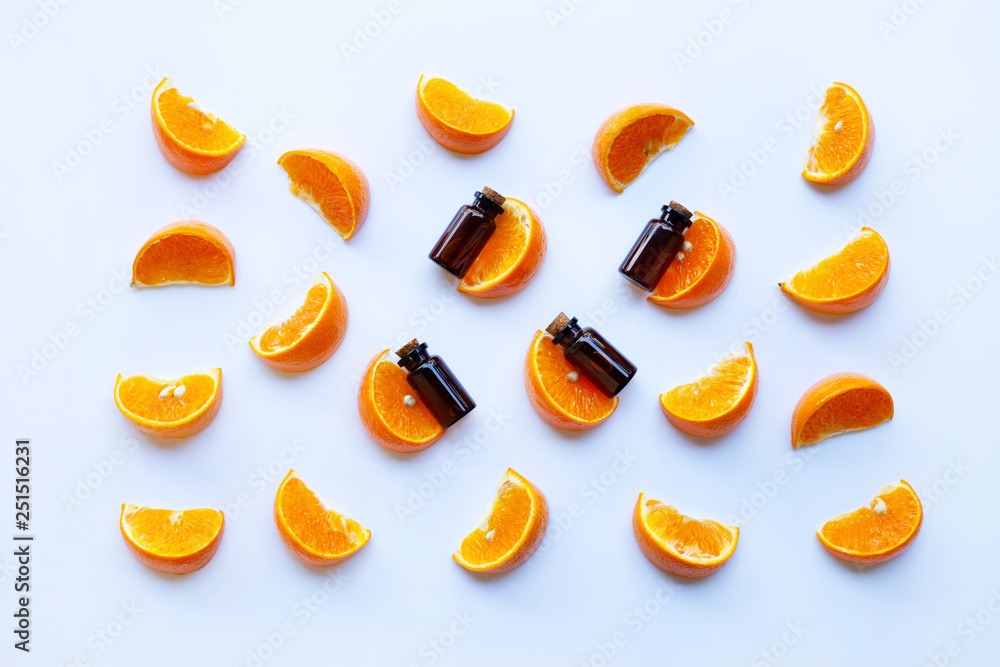 Essential oils with citrus fruits on white