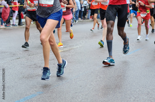 Marathon running race, many runners feet on road racing, sport competition, fitness and healthy lifestyle concept © Iuliia Sokolovska