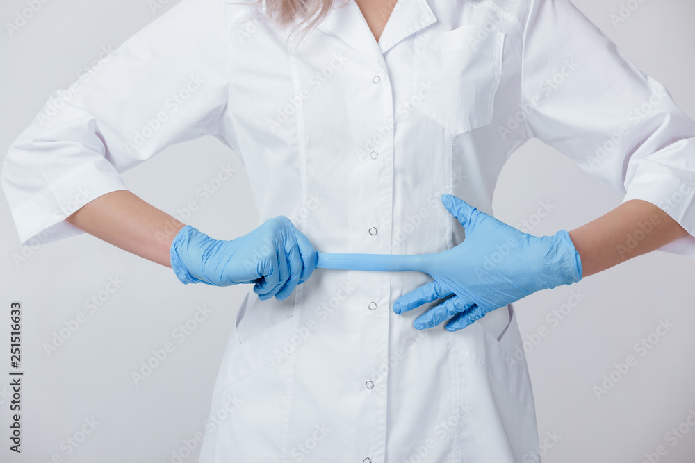 Woman doctor hands wears medical latex blue gloves, close-up Woman doctor hands wears medical latex blue gloves, close-up