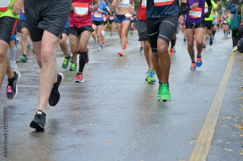 Marathon running race, many runners feet on road racing, sport competition, fitness and healthy lifestyle concept