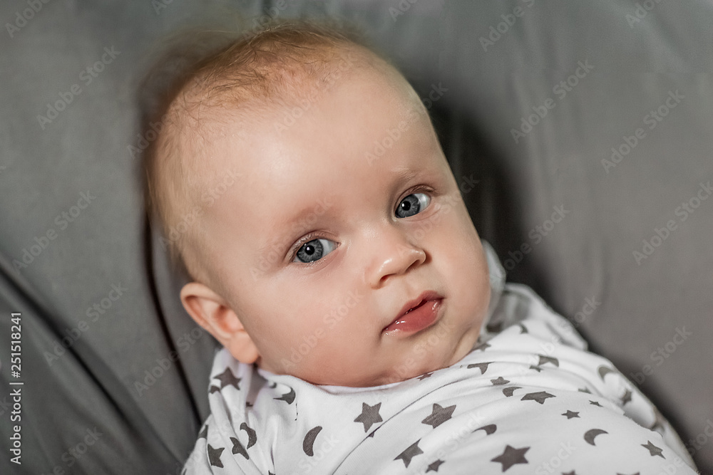 Portrait of a little baby who looks into the camera Portrait of a little baby who looks into the camera