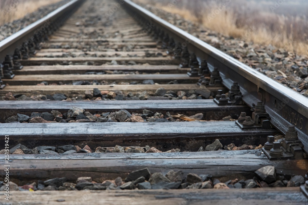 Φωτογραφία Detail of railway tracks with girder and gravel. Shallow DOF
