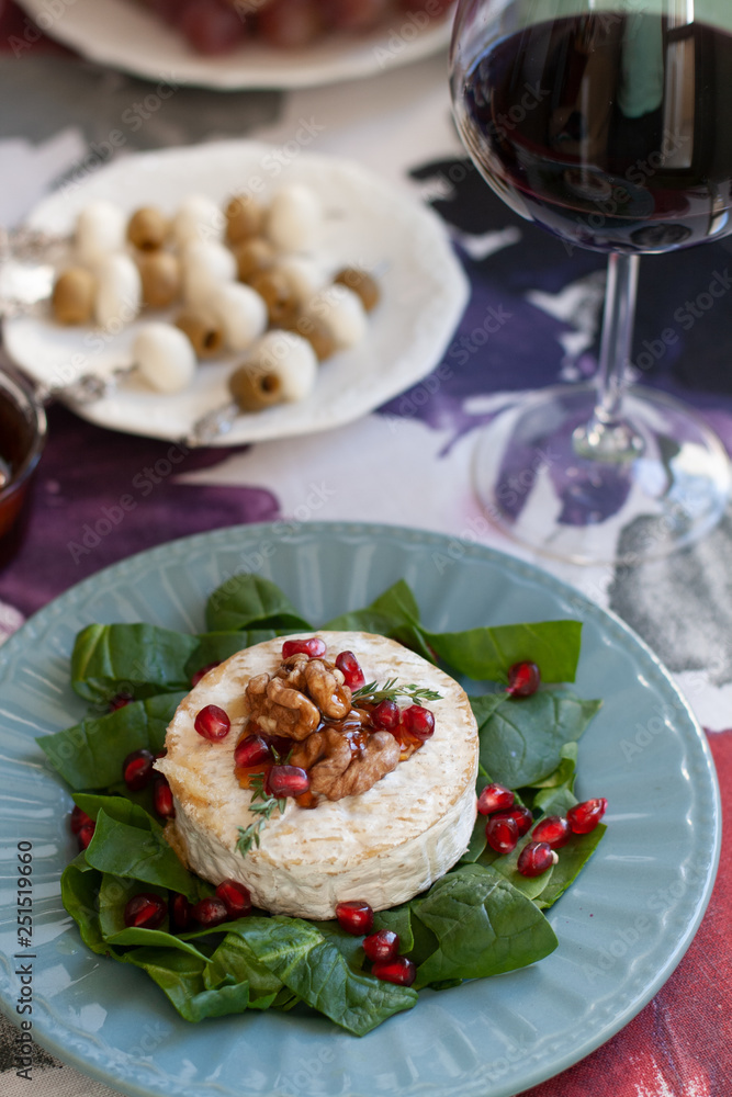 Healthy nutritious lunch or dinner for two: grilled camembert grenade grains. a string of rosemary and nuts 