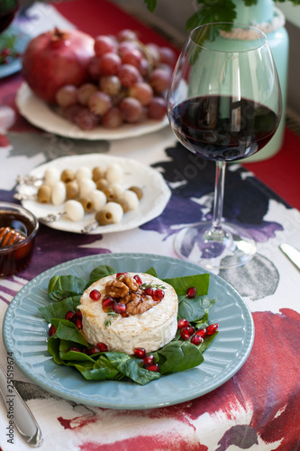 Healthy nutritious lunch or dinner for two: grilled camembert grenade grains. a string of rosemary and nuts 