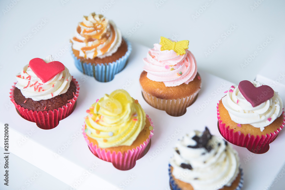 decorated cupcakes with strawberry, vanilla, caramel and chocolate frosting decorated cupcakes with strawberry, vanilla, caramel and chocolate frosting