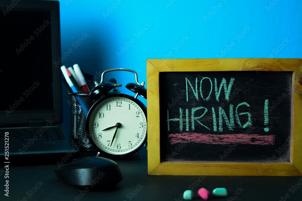 Now Hiring! Planning on Background of Working Table with Office Supplies. Business Concept Planning on Blue Background Now Hiring! Planning on Background of Working Table with Office Supplies. Business Concept Planning on Blue Background