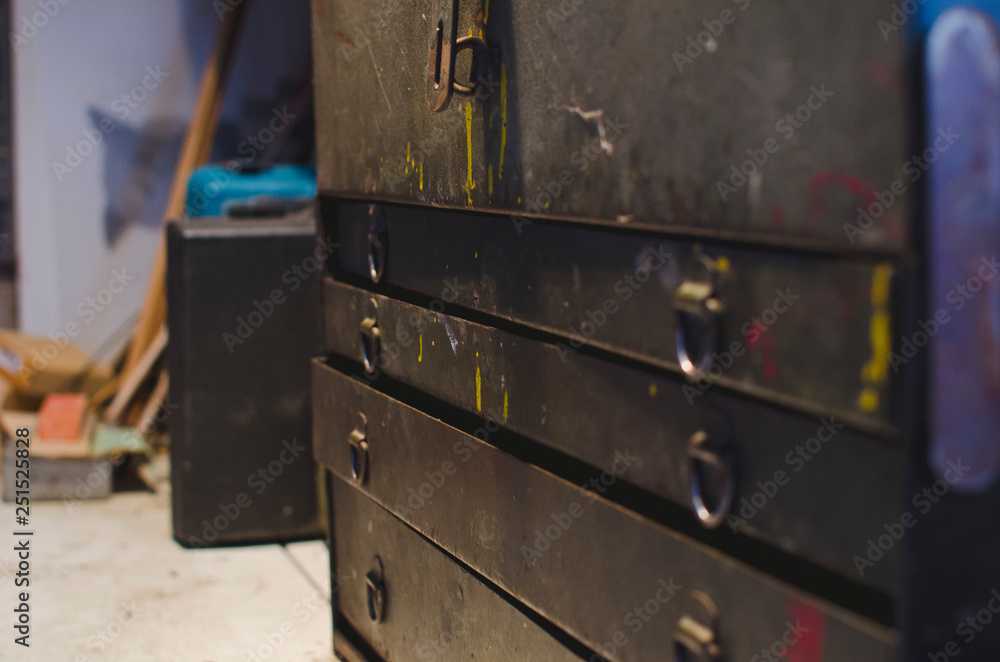A view across the front of the old vintage toolbox on the workbench of the old garage shop. A view across the front of the old vintage toolbox on the workbench of the old garage shop.