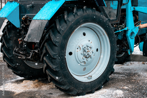 Black big wheel from the tractor. Snowblower. Equipment