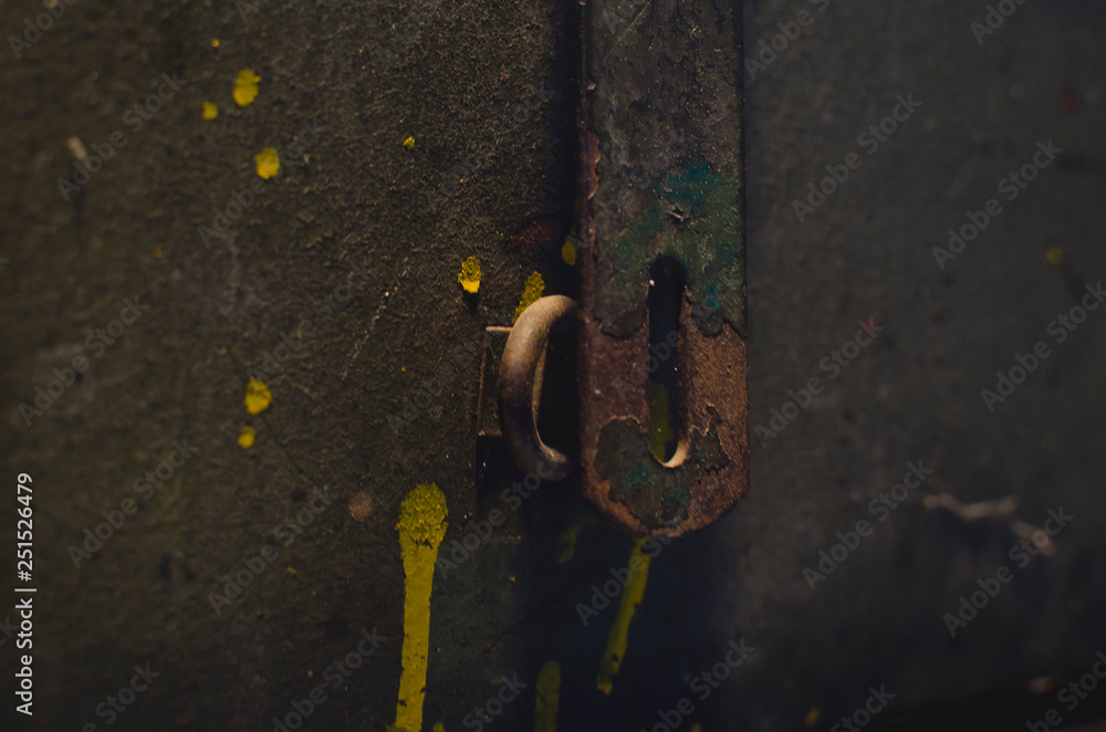 A detailed look at the rusty latch and lock on the front of the old toolbox. A detailed look at the rusty latch and lock on the front of the old toolbox.