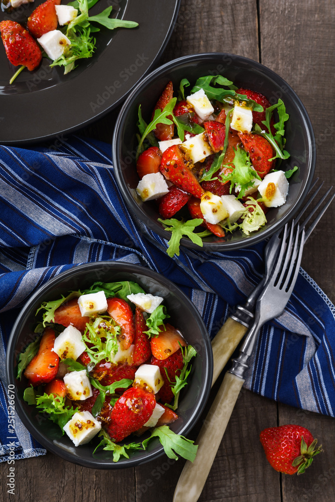 Vegetarian salad with strawberry, tofu and aragula overhead shot Vegetarian salad with strawberry, tofu and aragula overhead shot