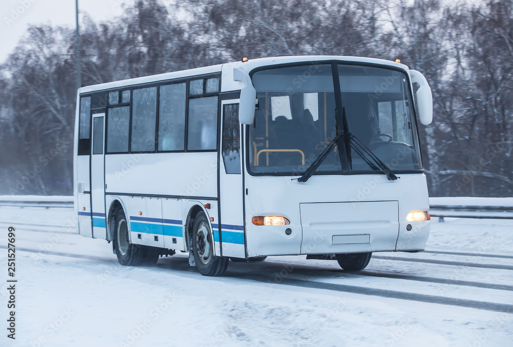 bus moves in winter along road