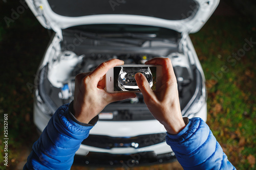hands take picture of new car engine and parts