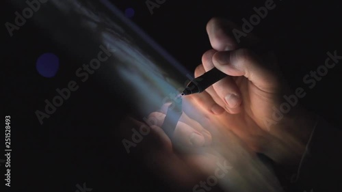 Creative Digital artist editing his artwork on interactive tablet computer at night home office