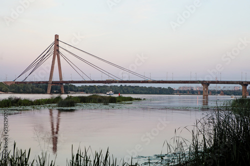 Large bridge over the Dnipro river in Kyiv Ukraine in sunset
