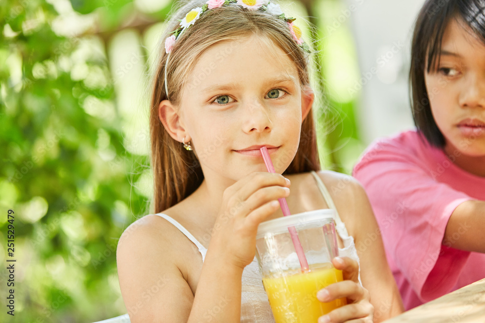 Girl drinks fresh orange juice for breakfast Girl drinks fresh orange juice for breakfast