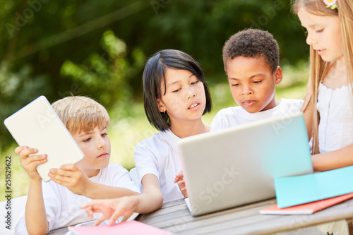 Group of kids in teamwork at laptop computer