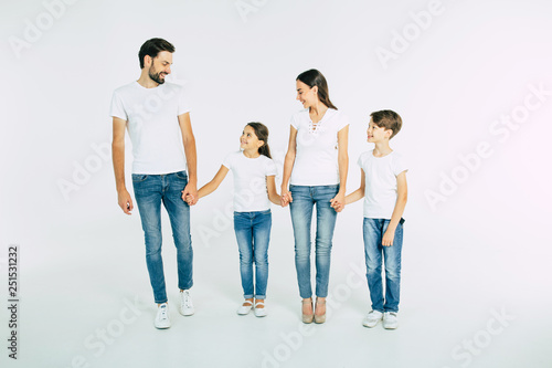Full length photo of happy beautiful family isolated on white background in T-shirt