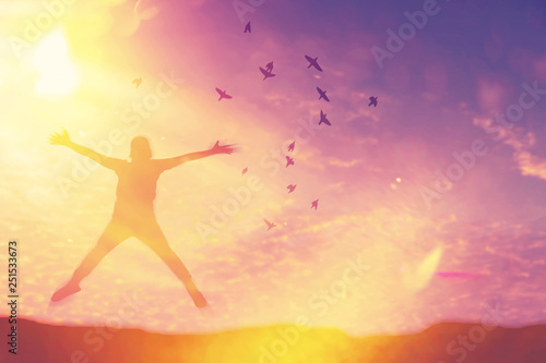 Silhouette man jump and birds fly on sunset sky and cloud texture abstract background.