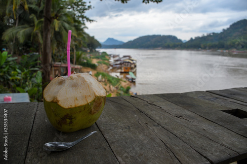 Young cococnut on wooden table photo