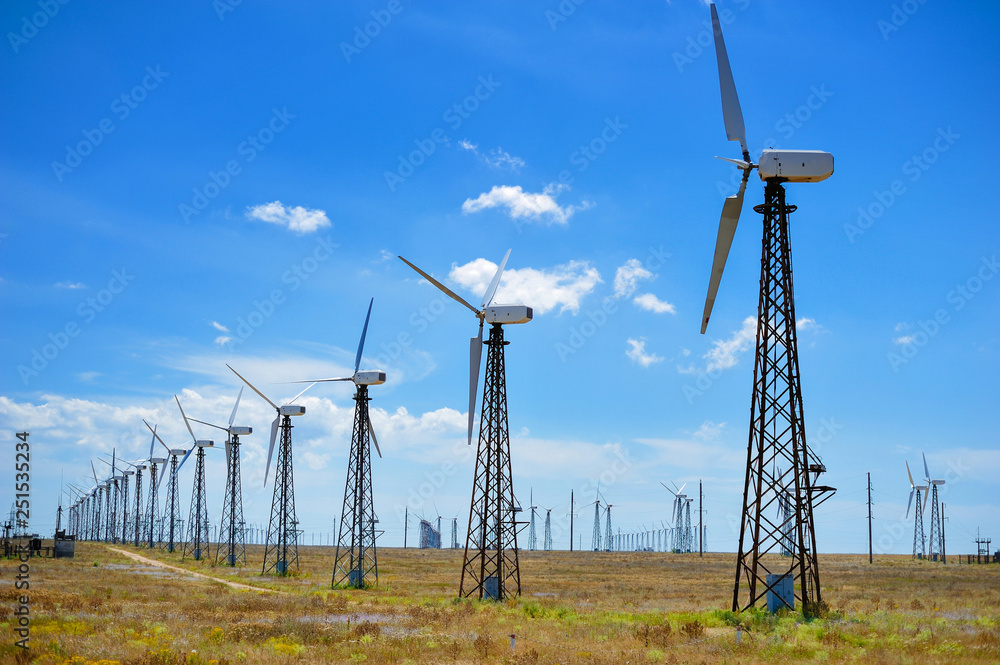 yellow steppe with wind turbines producing electricity yellow steppe with wind turbines producing electricity