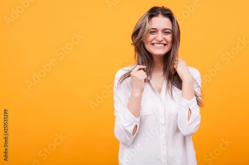 Happy young girl with big smile over yellow background