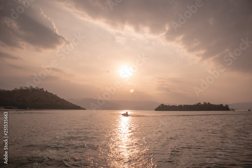 Warm and smooth sunset landscape view of big lake. © Sevendeman
